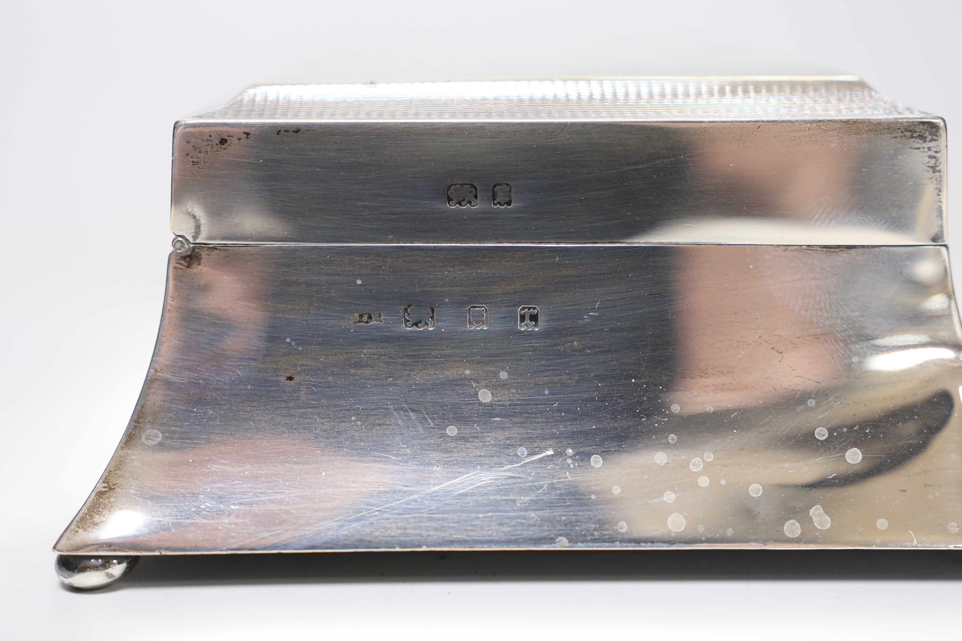 A George V Art Deco part engine turned silver mounted rectangular cigarette case, London, 1932, 15.2cm.